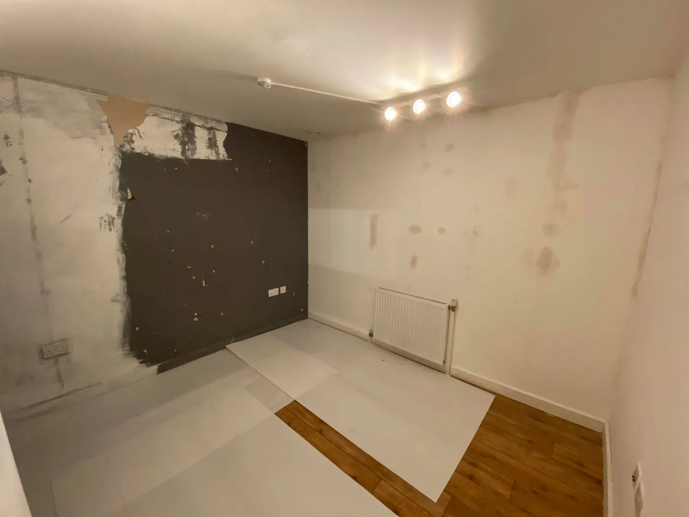Room protected and prepared with dust sheets before painting in a London property by Ferizi Property Services