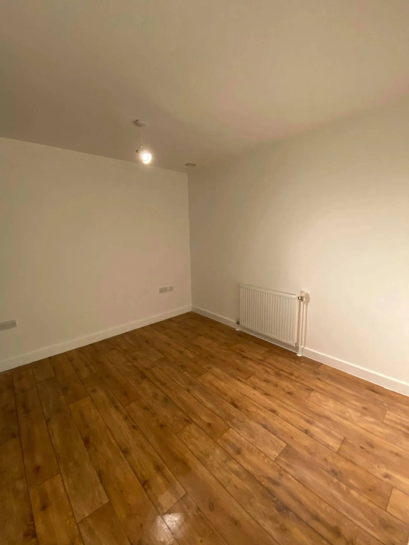 Freshly painted room with new LVT flooring installed in a London flat by Ferizi