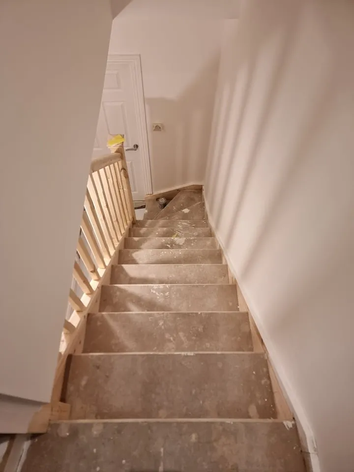 Staircase mid-way through repainting in a London property by Ferizi Property Services